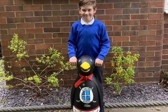 Bradley Law from Concord Junior School with their penguin Bob that he designed.