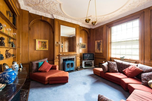 The living room is large and oak panelled with a wood burner.