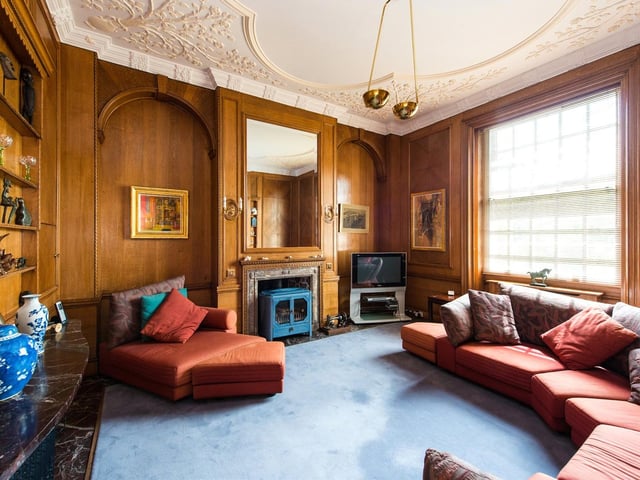 The living room is large and oak panelled with a wood burner.