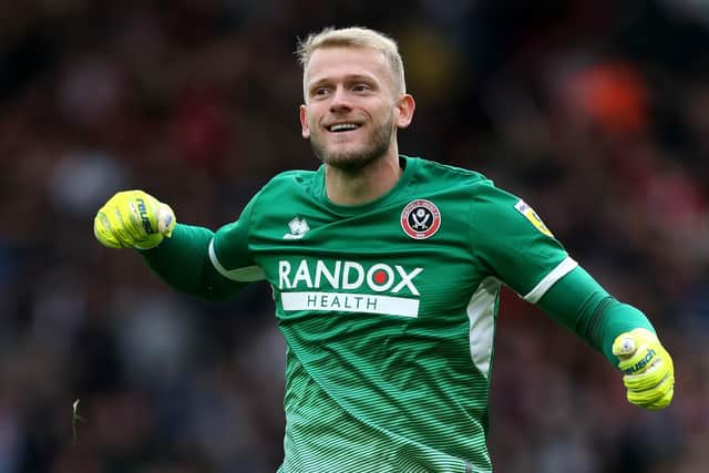 Sheffield United goalkeeper Adam Davies celebrates after team-mate Oli McBurnie scores his side's second goal during the Sky Bet Championship match at Bramall Lane: Barrington Coombs/PA Wire.