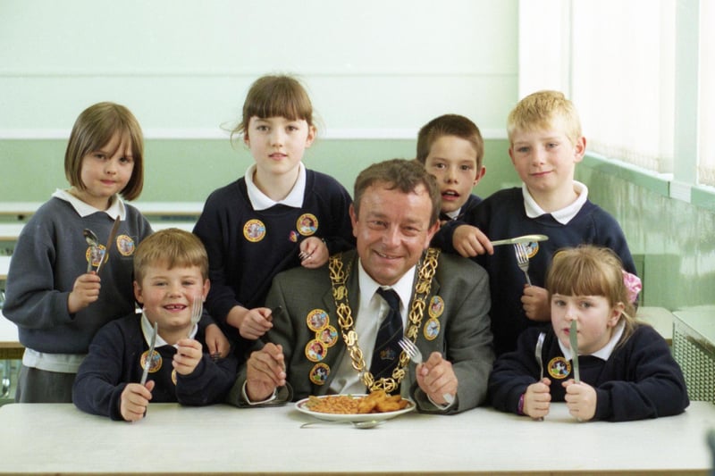 It's National School Meals Week in 1999 and The Mayor Sunderland, Coun Wally Scott, dons a Second World War helmet as part of lunchtime learning activities at Thorney Close Primary School. Were you pictured with him?