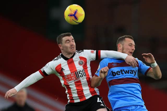 Sheffield United's John Fleck (L) jumps up for a header with West Ham United's Vladimir Coufal (R)  at Bramall Lane  (Photo by MIKE EGERTON/POOL/AFP via Getty Images)