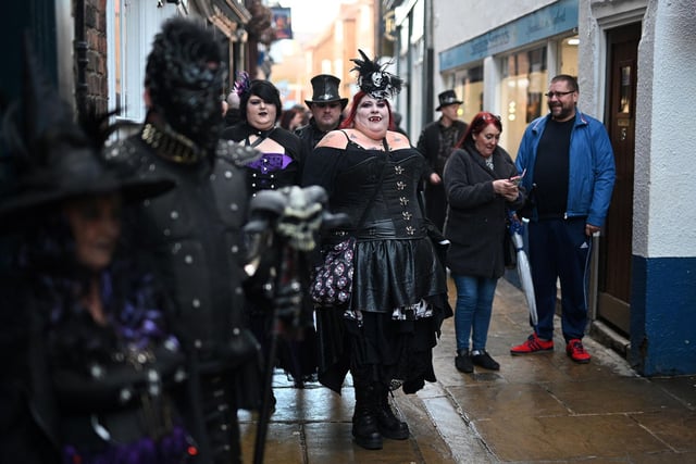 Participants in costume attend the biannual 'Whitby Goth Weekend' festival in Whitby, northern England, on October 31, 2021. - The festival brings together thousands of goths and alternative lifestyle fans from the UK and around the world for a weekend of music, dancing and shopping. (Photo by Oli SCARFF / AFP) (Photo by OLI SCARFF/AFP via Getty Images)