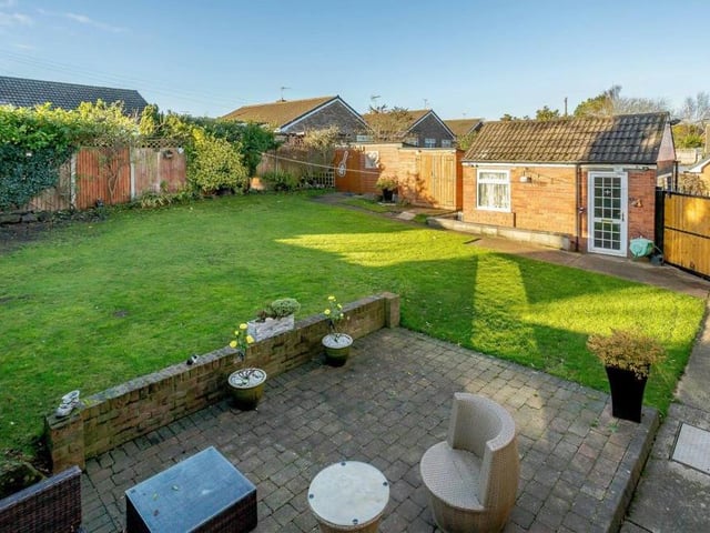 A more elevated view of the rear garden and its seating area. Because it benefits from a south-westerly aspect, you can enjoy the afternoon sunshine.
