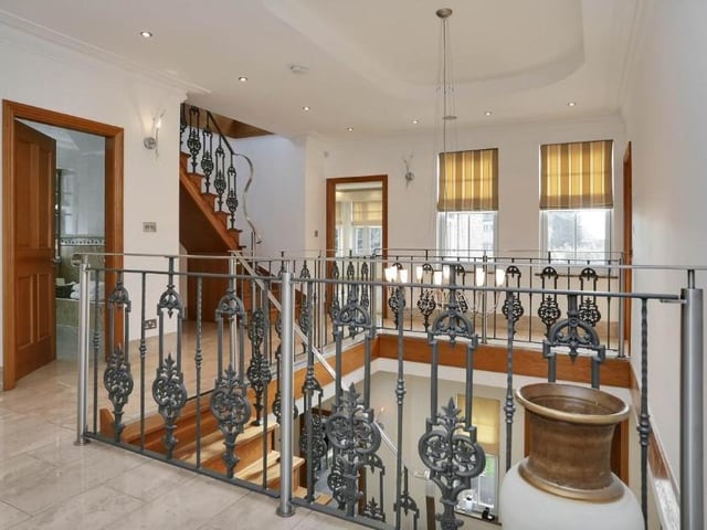 We're on our way to the first floor now as the oak stairs lead to this impressive galleried landing, with high ceiling. It gives access to five of the six bedrooms, with a further staircase leading to the sixth on the second floor.