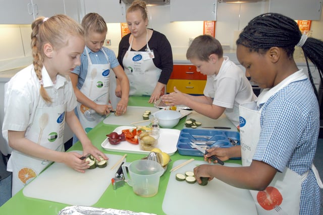 Michaela Bowles, centre, a teacher with Focus on Food pictured with pupils of Rainworth's Heathlands School when the Cooking Bus visited the school in 2007