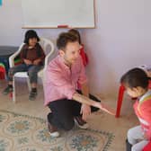 Coun Ben Miskell with a class of girls whilst on a visit to Palestine, a region where he says children can also struggle with barriers to their right to education