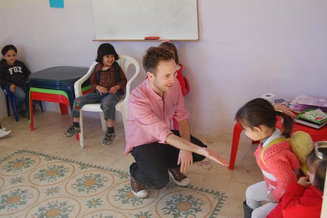 Coun Ben Miskell with a class of girls whilst on a visit to Palestine, a region where he says children can also struggle with barriers to their right to education
