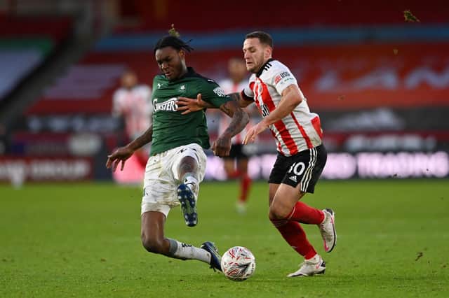 Jerome Opoku of Plymouth Argyle is fouled by Billy Sharp of Sheffield United during The Emirates FA Cup Fourth Round match between Sheffield United and Plymouth Argyle at Bramall Lane . (Photo by Stu Forster/Getty Images)