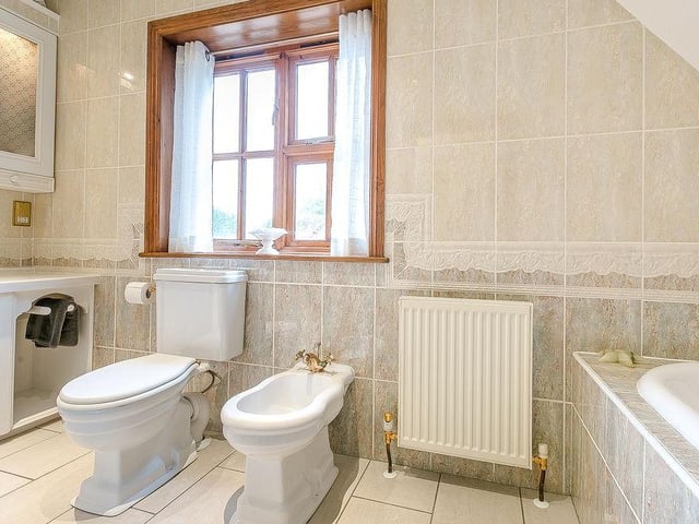 The en suite facilities for another of the bedrooms. Bath, WC and bidet are among the features.
