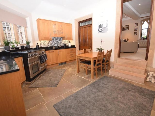 Let's begin our tour of the coach house by stepping in to the welcoming and spacious kitchen diner. It has a unique shape and design, with bespoke fittings, and a useful, separate utility room/cloakroom. Beautifully crafted solid-oak wall and base units are complemented by a high-end Black Star granite work surface. The stairs lead up to the living room.