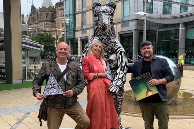 Dorothy Laflin (Selket) and Philip Lisberg, left, on a visit last year to see the Bears of Sheffield. City artist Tom Newell, right, named his bear Quasar One, after Ramases' song. Tom is holding a copy of the Ramases album Space Hymns which featured the track