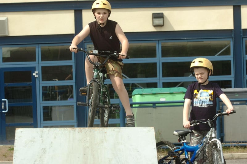 Adam Bagnall tries out his BMX skills at Beck Road School as part of summer holiday events held by council officials as Sam Bagnall awaits his turn