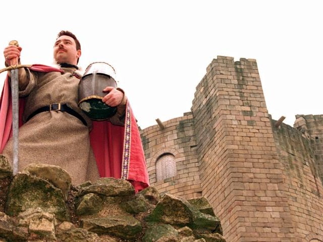 Castle guide John Martin dressed as a knight standing guard.