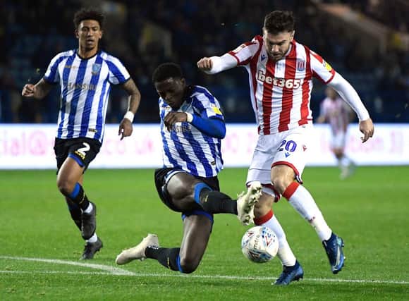 SHEFFIELD, ENGLAND - OCTOBER 22: Dominic Iorfa of Sheffield Wednesday tackles Scott Hogan of Stoke City during the Sky Bet Championship match between Sheffield Wednesday and Stoke City at Hillsborough Stadium on October 22, 2019 in Sheffield, England. (Photo by George Wood/Getty Images)