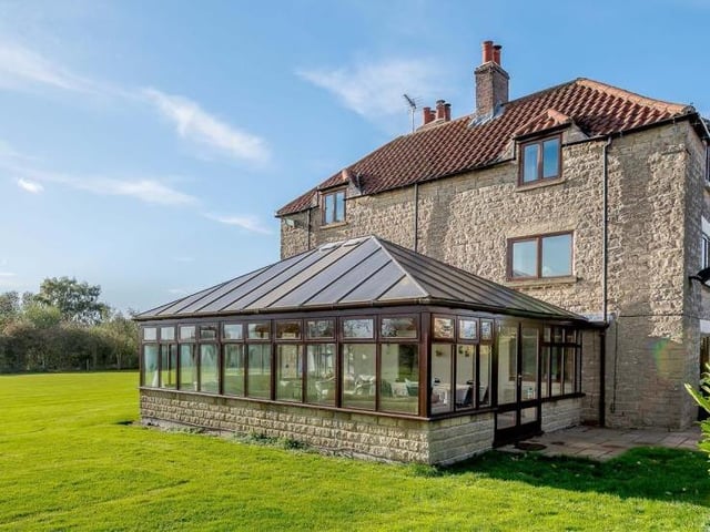 The property from another angle, showing the large conservartory.