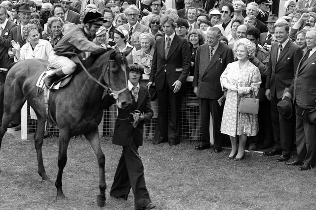 The Queen Mother smiles as Dunfermline, ridden by Willie Carson walks past the paddock after winning the Jubilee Oaks race at Epsom.