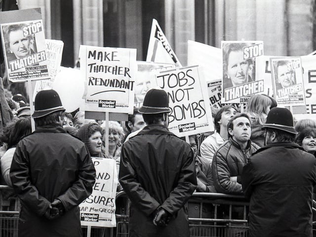 Protestors gather outside Sheffield Cathedral as Margaret Thatcher visits the Cutlers Hall on April 28, 1983
