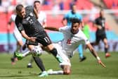 Croatia's forward Ante Rebic (L) and England's defender Tyrone Mings vie for the ball during the UEFA EURO 2020 Group D football match between England and Croatia.