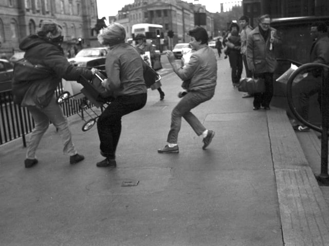 Passers-by rush to stop a baby's pushchair being blown away at Edinburgh's Waverley Steps during the gales of November 1981.