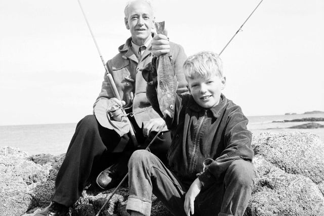 Mr F McIvor and his son hold up a rock cod after a successful sea fishing expedition to North Berwick in September 1963.