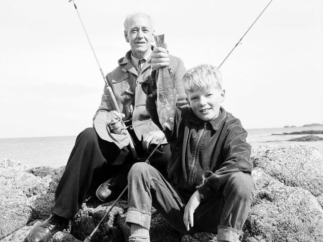 Mr F McIvor and his son hold up a rock cod after a successful sea fishing expedition to North Berwick in September 1963.