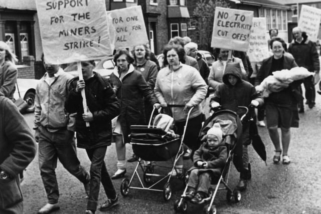 Striking miners and their families stage a protest march to highlight the threat of electricity being cut off at miners' homes because of non payment of bills, in May 1984
