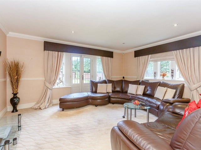 A further family sitting room provides an additional area for relaxing and entertaining, with the double doors leading out into the private rear garden.