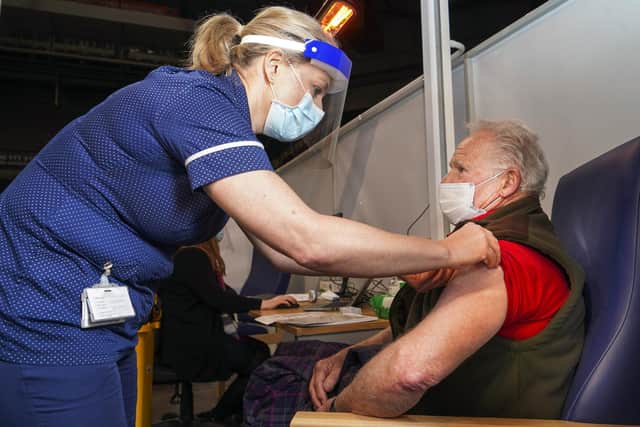 Sally Conlan Deputy Nurse Director for the Covid 19 Vaccination Programme vaccinates Colin Moss  at the Covid 19 max vaccination centre which has opened at the Sheffield Arena. Picture Scott Merrylees