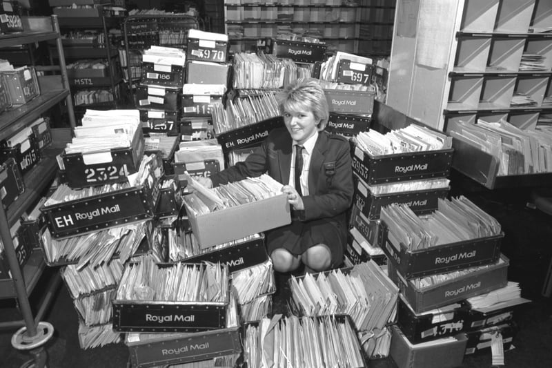 Royal Mail postal worker Barbara Wilson sorts out the Christmas post at Brunswick Road sorting office in Edinburgh, December 1987.