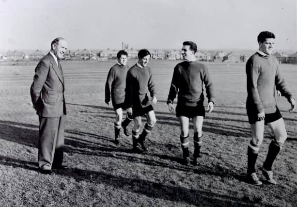 The late Manchester United and England footballer David Pegg (fourth left) looks towards Matt Busby (left), later Sir Matt Busby, with fellow players, from left, Wilf McGuiness, Dennis Violet and Tommy Taylor also pictured.