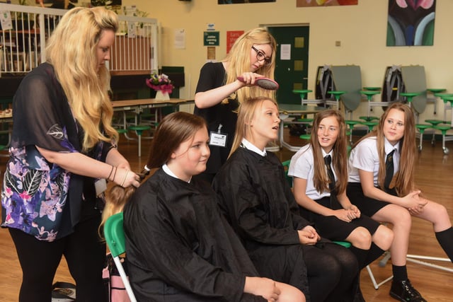 A charity hair cut at Manor Academy in 2015. Abi Herbert (left) and Jodie Richardson of The Little Hair & Beauty Boutique, Greatham Village, were cutting the hair of left to right Mia Levitt, Holy Gale, Lucy Burnett and Louise McCann.