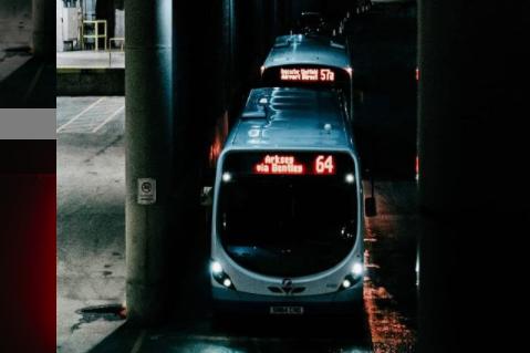 Buses leaving the bus station at night.