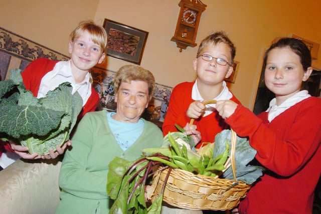 Children from Bentley High Street School presented residents at Minden Court Residential Home with fruit and vegetables from their Harvest Festival back in 2007. L-R are Kelly Cook, Ben Wright, both ten, and Bethyn Saunders, eight, with resident Vivian Thomas, 80