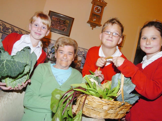 Children from Bentley High Street School presented residents at Minden Court Residential Home with fruit and vegetables from their Harvest Festival back in 2007. L-R are Kelly Cook, Ben Wright, both ten, and Bethyn Saunders, eight, with resident Vivian Thomas, 80