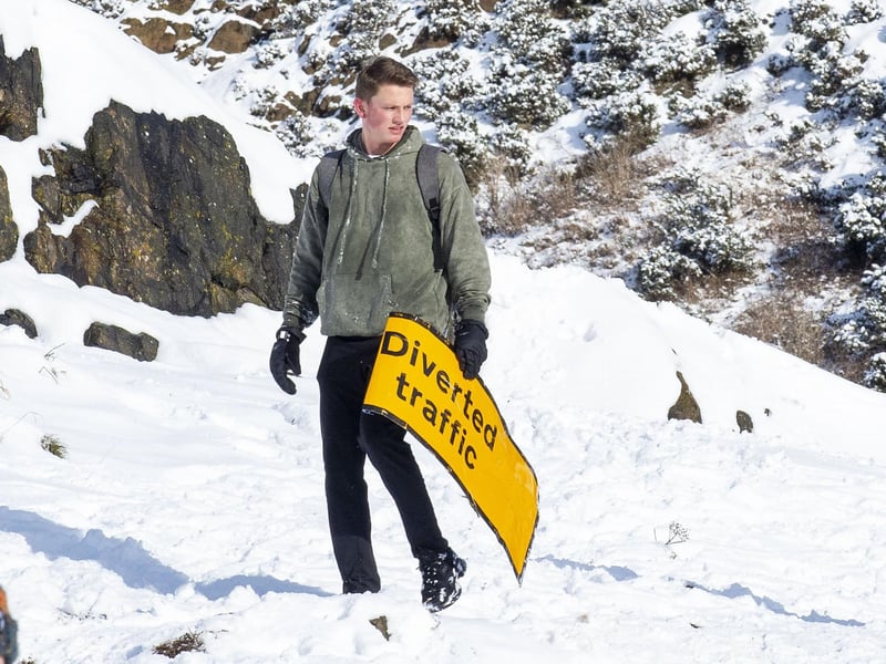 Another punter uses a road sign as a sled.