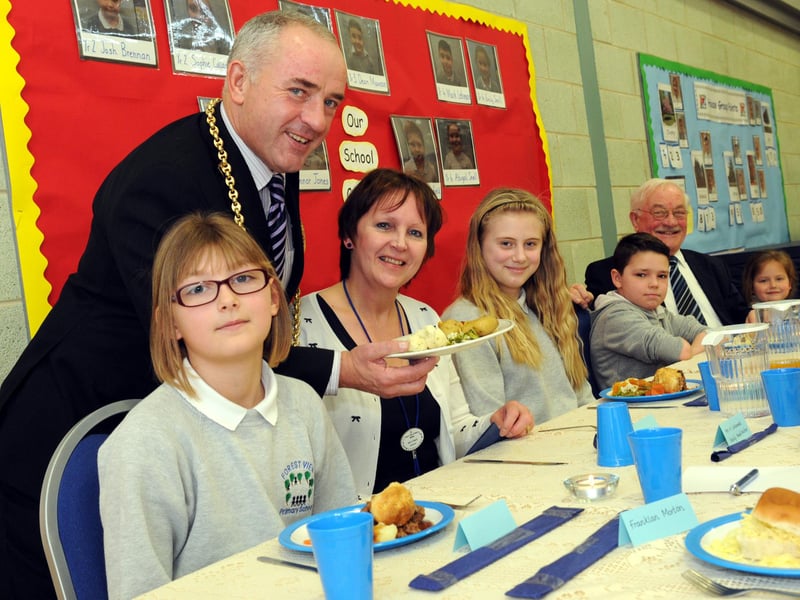 The Mayor Coun Ernest Gibson serves lunch to Forest View Primary School headteacher Cheryl Ward and school council members in 2014.
