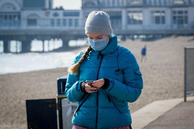 A woman wears a mask in Southsea on March 27.