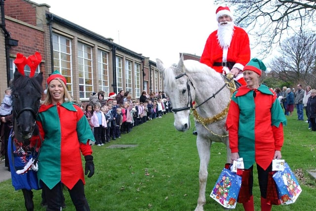 Father Christmas makes his big arrival at Downhill Infants. Can you spot your child in the background?