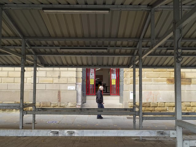 A solitary shopper strolls through the Market Place.