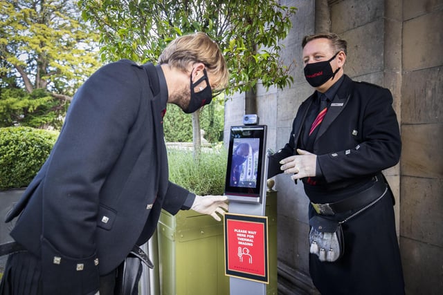 House manager Derek West (left) and general manager Alan McGuiggan check their temperature using a thermal camera before starting work with preparations at Prestonfield House in Edinburgh before the hotel reopens