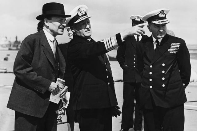 Admiral Sir Geoffrey Layton, Commander-in-Chief, Portsmouth, points out 'Colossus' to Prime Minister Clement Attlee (left), 6th August 1946. Attlee is in Portsmouth to oversee the handover of the vessel to the French, as a loan.
