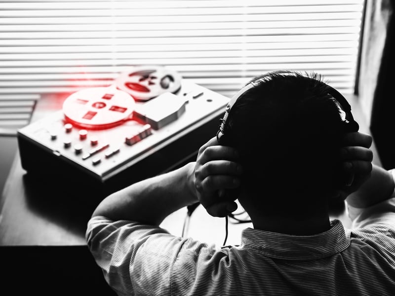 Special agent listens on the reel tape recorder.