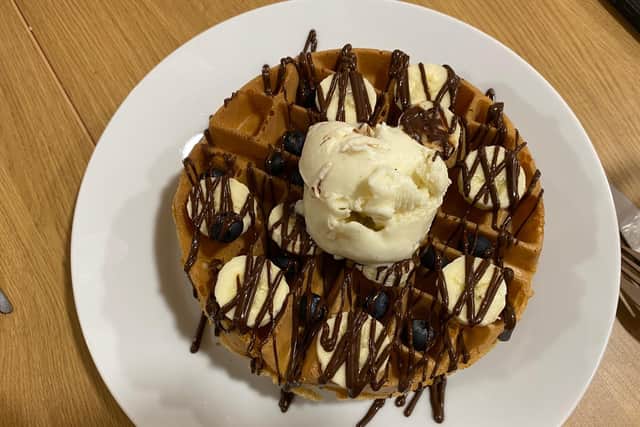 A waffle with customised toppings - bananas and blueberries that is drizzled with Belgian chocolate sauce and a scoop of vanilla ice cream (£5.29).