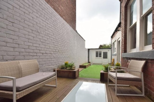 The property offers outdoor space by way of a landscaped courtyard with artificial grass, decked area and a large garage. 

Image by Peter Heron/Zoopla.