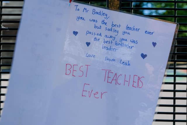 Tributes left on the railings at Westways Primary School after Assistant Head David Bradley passed away suddenly. Picture by Dean Atkins