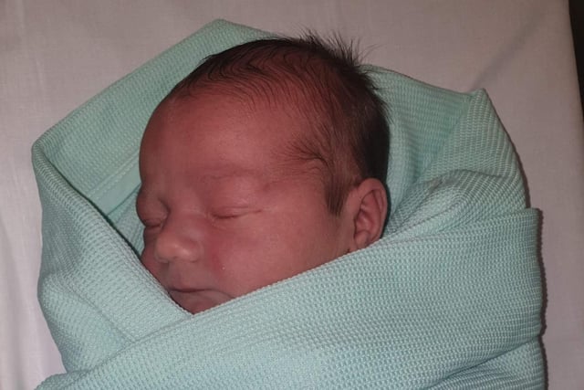 Owen Mansfield came into the world in the back seat of a car near the Commonwealth Pool on 23 April 2020 . Midwives at RIE were on hand to assist once parents Phil and Carrie reached the hospital