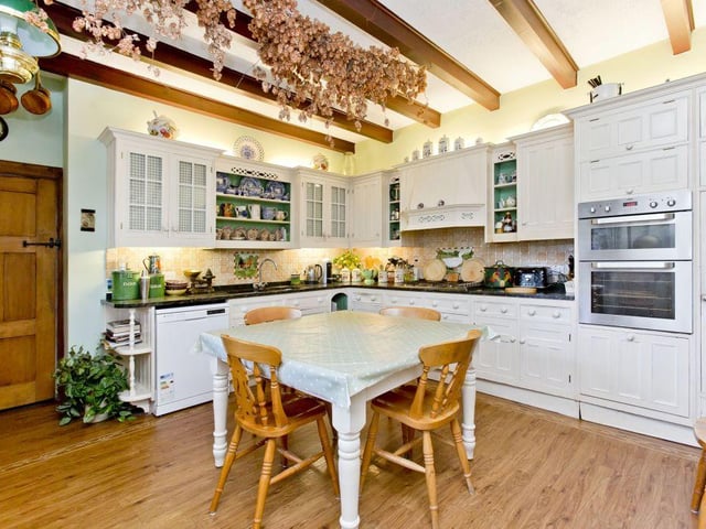 At the heart of the family home is a cosy dining kitchen, kitted out with stylish cabinets and granite countertops.