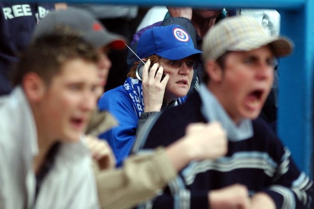 Spireites escape relegation on the last day. One supporter listens to the scores on the radio.
