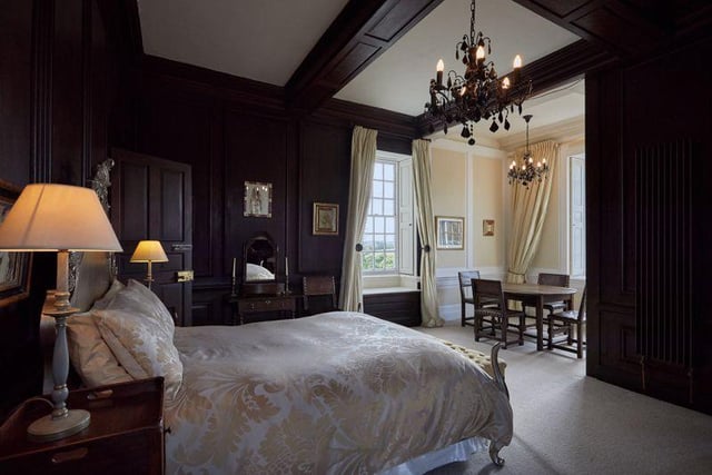 There are five bedrooms throughout the property, including this grand master room with south facing views, a window seat and seating area overlooking the grounds.